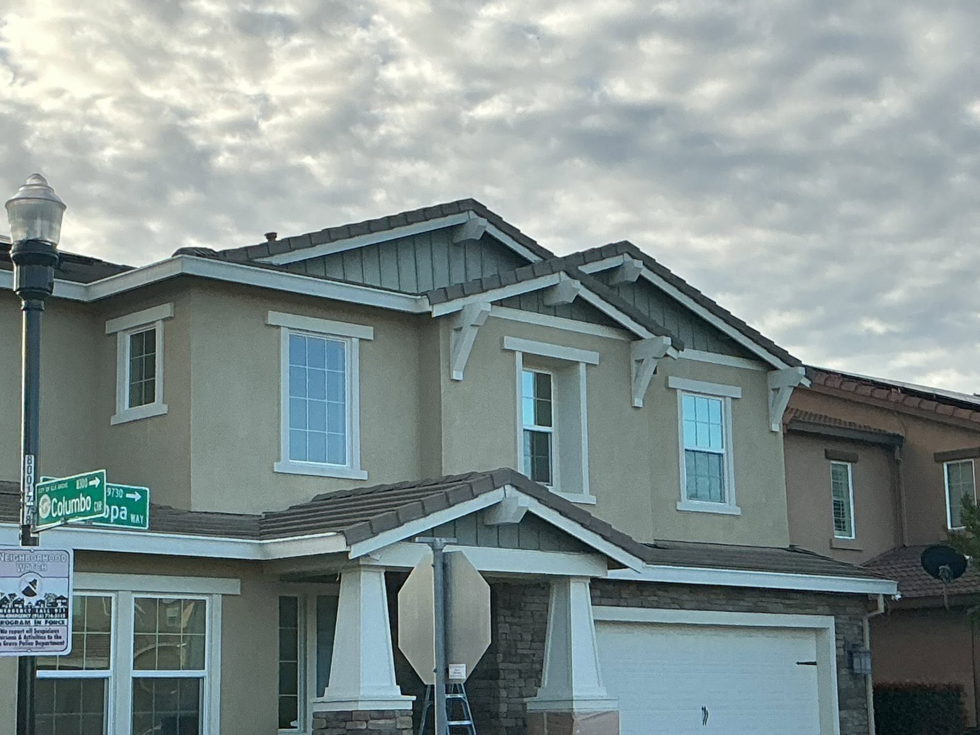 Completed tan and slate craftsman two-story exterior