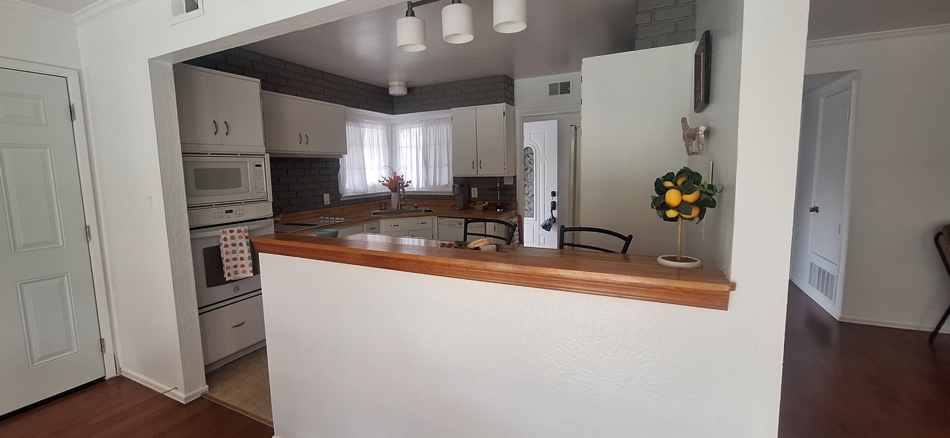 Refreshed kitchen with painted brick and light walls
