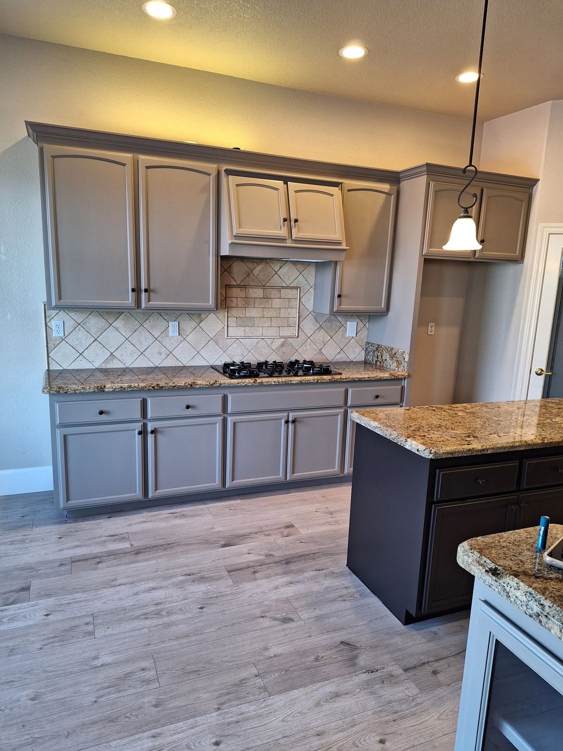 Warm taupe kitchen cabinet refinish with granite counters