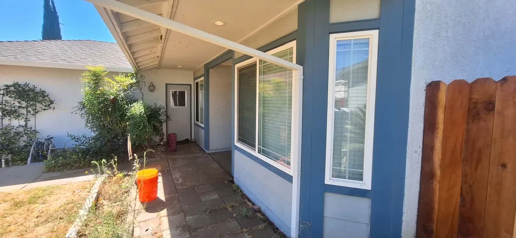 Blue accent siding with white porch trim repaint