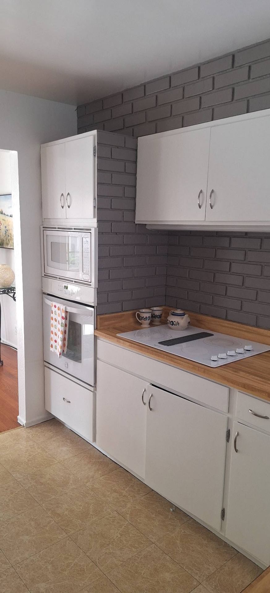 Kitchen with newly painted gray brick backsplash