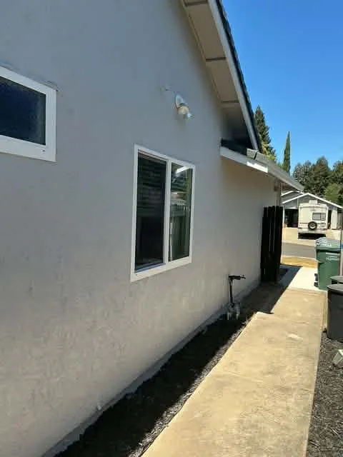 Fresh white stucco exterior with crisp white window trim